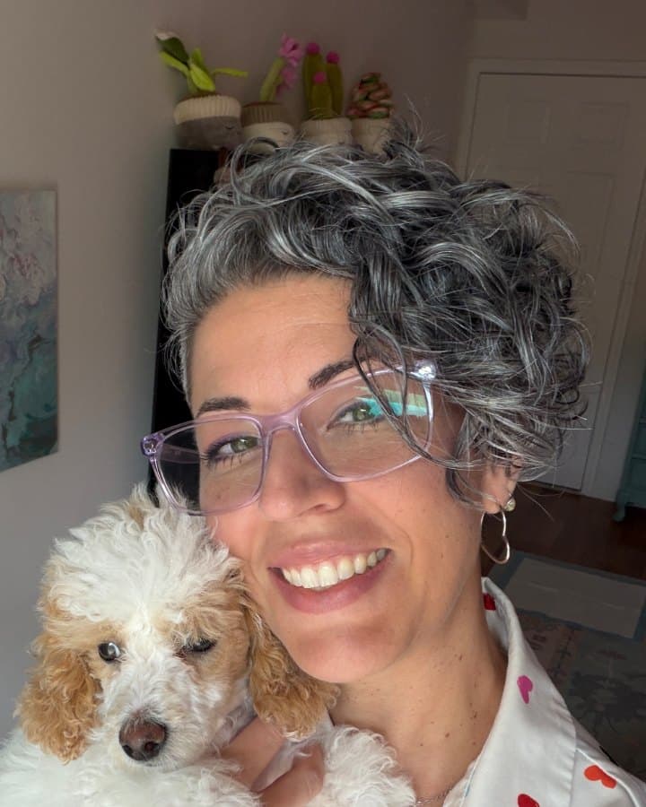 Natalie Calzadilla smiling with her poodle